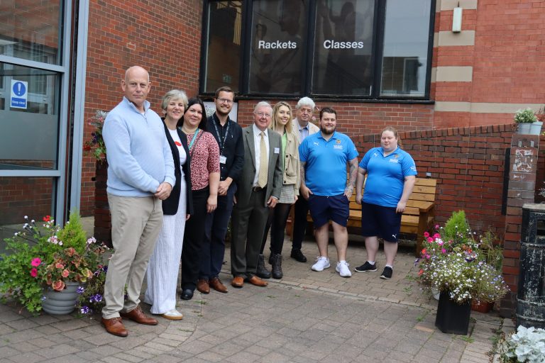 A group who attended the Portland Centre's CPT opening ceremony pose for a photo outside the centre,.